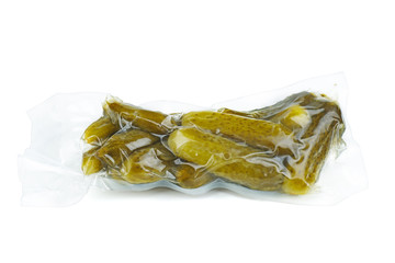 Marinated pickled cucumbers in plastic vacuum package isolated on white