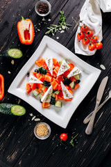 Flat lay salad with pepper, cucumber, olives, feta and dried spices