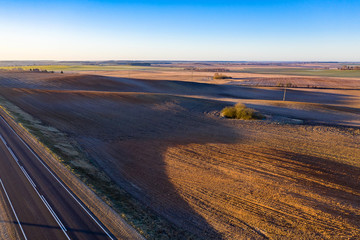 Rural panorama of spring agriculture fields. Beginning of gardening season, picturesque aerial view.