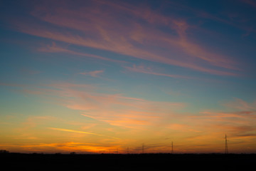 colorful sunset in Serbia with power grid in the background