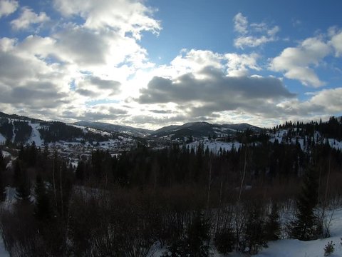 snowy mountains and sky with clouds