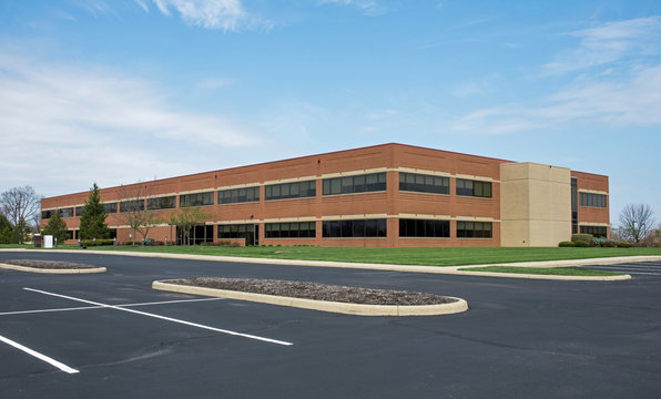Large Red Brick Building with Front Parking Lot
