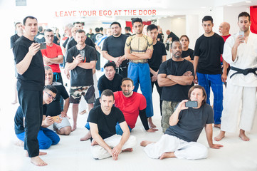 Large multiethnic group of sport students in dojo. Front view