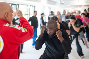 Group of sport multiethnic students have boxing training under rope