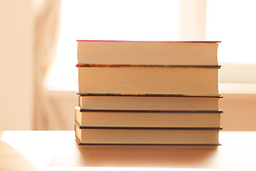 close up of a stack of books on the table