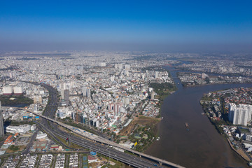 Fototapeta na wymiar Top view aerial photo from flying drone of a Ho Chi Minh City with development buildings, transportation, energy power infrastructure