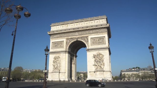 Paris street with the Arc de Triomphe in Paris, France.