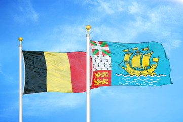 Belgium and Saint Pierre and Miquelon two flags on flagpoles and blue cloudy sky