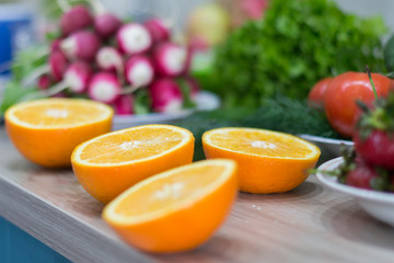 Fresh oranges and vegetables on a background.