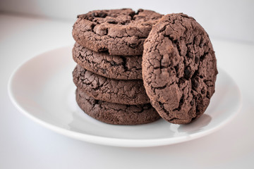 Some chocolate chip cookies on a white plate