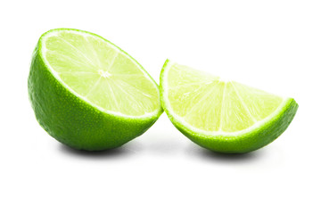 lime on a white background. two slices of lime lovely fruit. kind of citrus