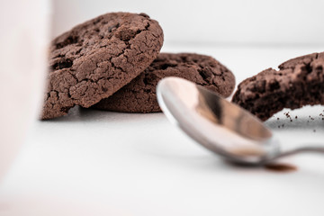 Broken chocolate cookies on a white background
