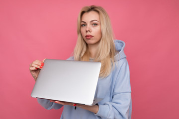 A young girl holds a laptop in her hands . Concept of working outside the office