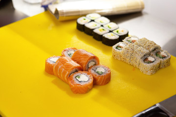 Chef makes rolls Philadelphia with salmon.