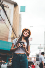 Young asian traveller woman with instant camera in Bangkok, Thailand