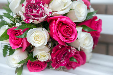 wedding bouquet of fresh roses on white background, close up.