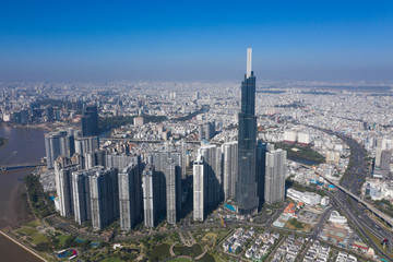 Fototapeta premium Top view aerial photo from flying drone of a Ho Chi Minh City with development buildings, transportation, energy power infrastructure