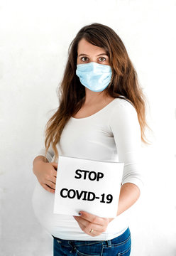 COVID-19 Pandemic Coronavirus Pregnant woman  wearing face mask protective for spreading of disease virus SARS-CoV-2. Pregnant girl with protective mask on face against Coronavirus Disease 2019.