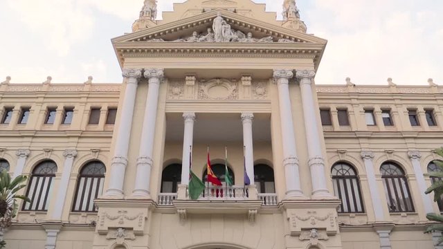 Beautiful Malaga Town Hall. Opened in 1919 is the work of the architects Guerrero Strachan and Rivera Vera. It has a neobaroque style. Cloudy day. Tilt Down