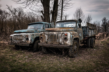 two very old trucks