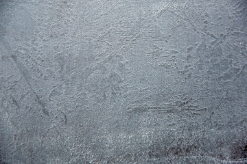 Grainy light grey stone background texture, close-up