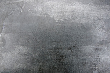 Grainy light grey stone background texture, close-up