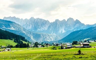 View on Alps mountains with green fields and cloudy sky. Gosau,  Salzburger land nearby Salzburg,...