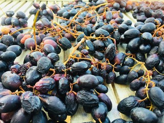 Purple Grapes on wooden table. Fruit Photography. Healthy Nutrition. Dark Grapes on wood.
