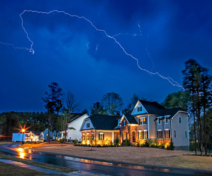 Powerful lightning storm front passes over residential houses