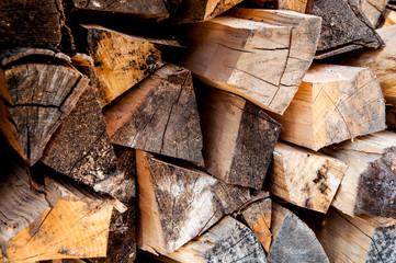stacked chopped firewood. timber bars at a sawmill