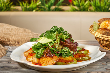 Hot snack. Warm salad of vegetables, herbs, meat. Grilled chicken breast with vegetables 