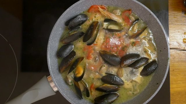 cooking in a pan with olive oil mussels, claims, shrimps for pasta allo scoglio