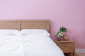 bedroom Interior of room with comfortable bed near pink wall,