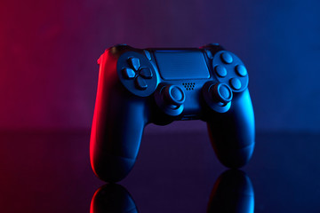  Sony Playstation 4 (PS4) DualShock 4 controller, videogame joystick or gamepad on a table. Close up studio shot. Game concept © bondvit