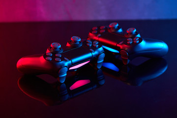  Sony Playstation 4 (PS4) DualShock 4 controller, videogame joystick or gamepad on a table. Close up studio shot. Game concept © bondvit