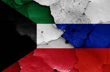 flags of Kuwait and Russia painted on cracked wall