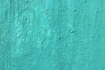 Beautiful vintage blue background with old blue paint with a rough surface, streaks and uneven texture of blue paint on an old rough surface