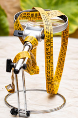 Yellow dressmaker's tape measure for clothing and its derivatives