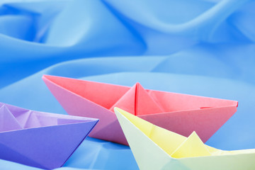 paper boats on a blue background