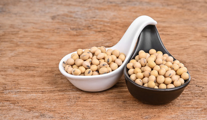 Soybeans on a  spoon, placed on a wooden