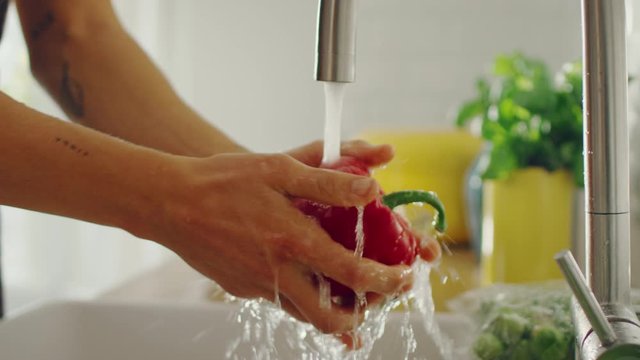 Close Up Footage of a Person Washing Red Sweet Pepper with Tap Water
