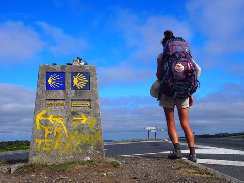 Pilgrim and Camino waymark at the Finisterre and Muxia, Camino de Santiago, Way of St. James, Journey from Santa Marina to Dumbria, Fisterra-Muxia way, Spain