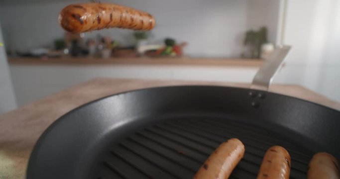 Roasted sausage is took away from the hot pan by fork, grilled sausages, cooking hot dogs with meat products , cooked chicken, 4k 60p 10 bit Prores HQ 422