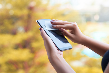 Cleaning mobile phone screen with disinfecting wet wipes . 