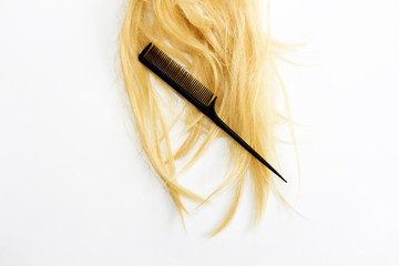 natural shaggy crumpled yellow blonde curl and a black comb