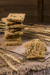 Multigrain Cereal Crunchy Squares Bars with Pumpkin Seeds Background. Healthy Bar Snack. Selective focus.