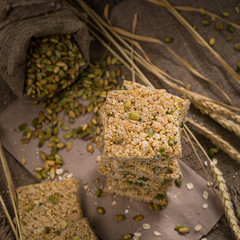 Multigrain Cereal Crunchy Squares Bars with Pumpkin Seeds Background. Healthy Bar Snack. Selective focus.