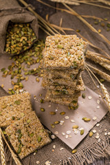 Multigrain Cereal Crunchy Squares Bars with Pumpkin Seeds Background. Healthy Bar Snack. Selective focus.