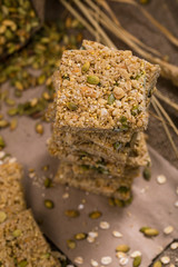 Multigrain Cereal Crunchy Squares Bars with Pumpkin Seeds Background. Healthy Bar Snack. Selective focus.