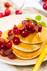 Healthy Homemade Classic American Pancakes with Sliced Red Grapes and Maple Syrup Close Up. Selective focus.